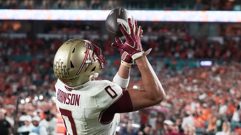 Florida State wide receiver Duce Robinson scores a touchdown during overtime of an NCAA...