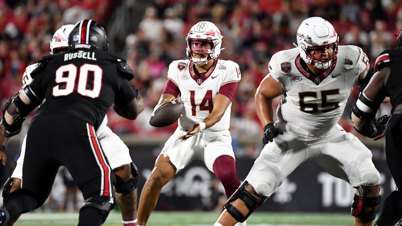 Florida State quarterback Ashton Daniels (14) takes a snap during the first half of an NCAA...